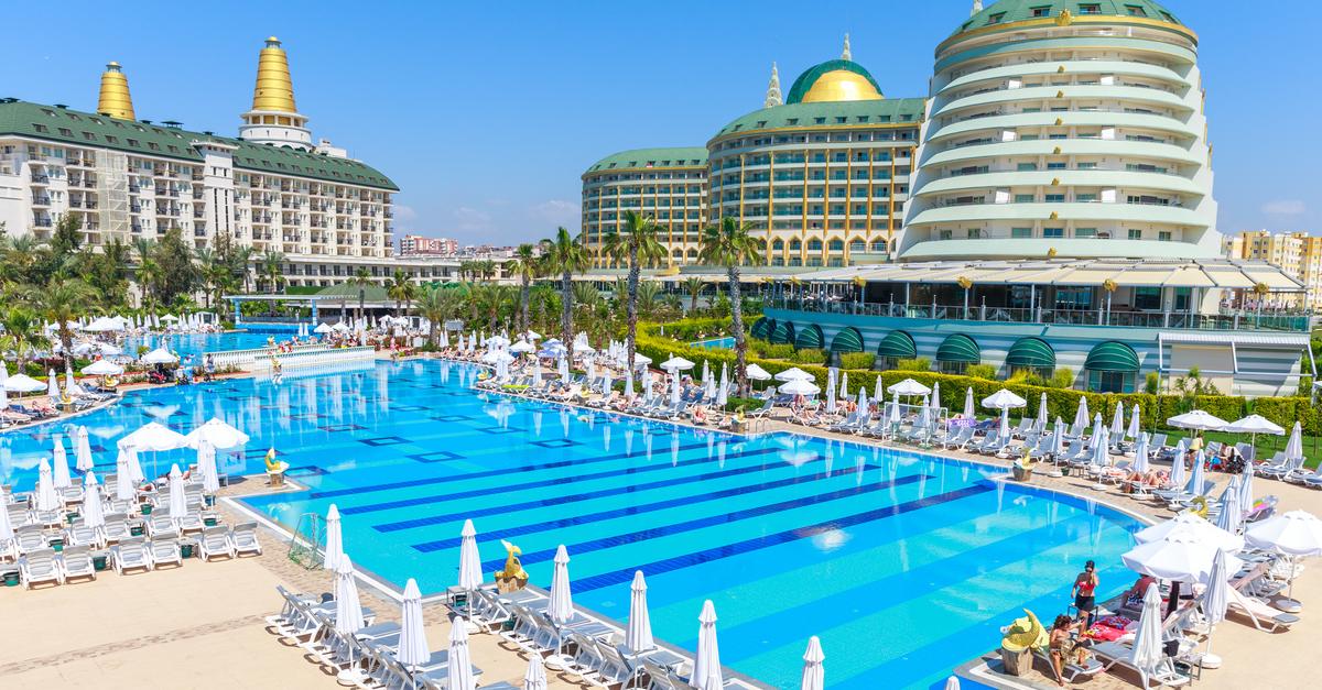 Velik bazen z ležalniki pred hotelom v Turčiji.